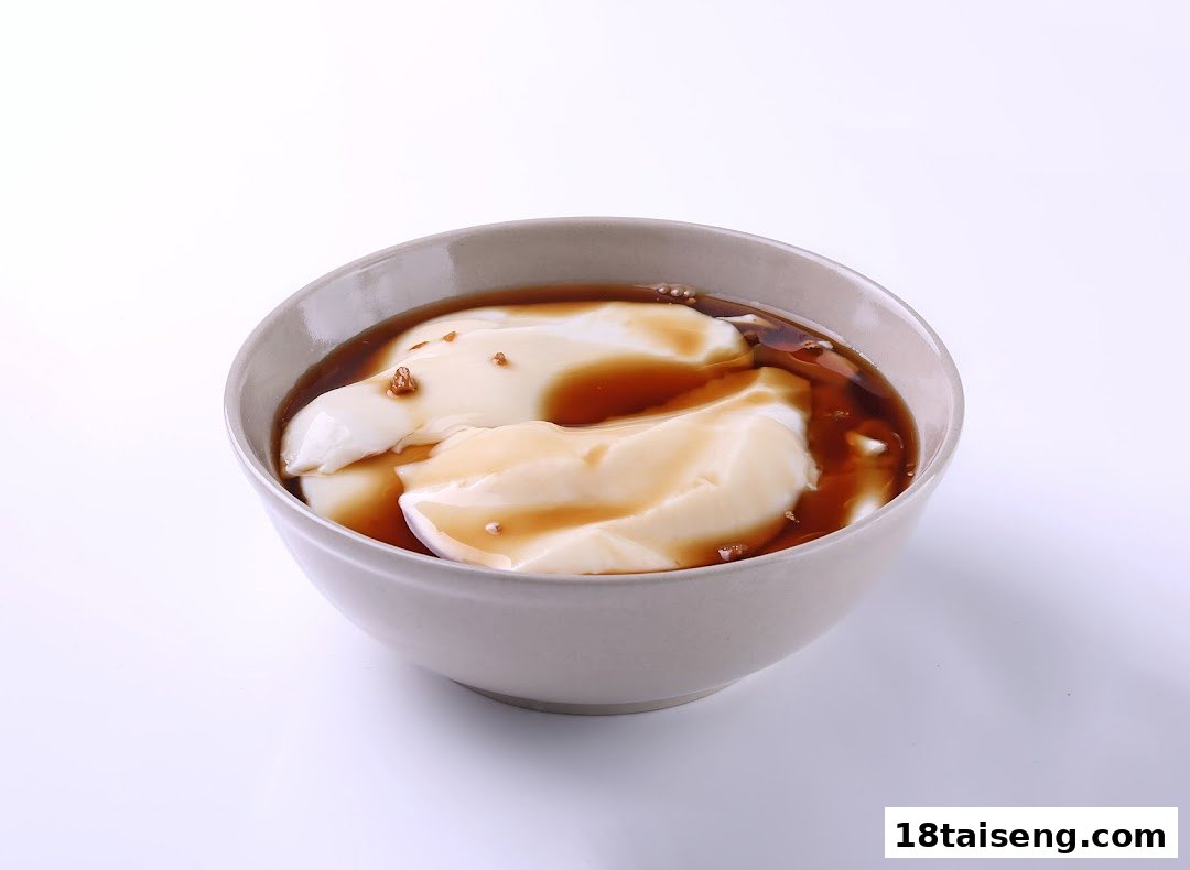 A bowl of smooth soy pudding (tau huay) with brown sugar syrup and toppings.