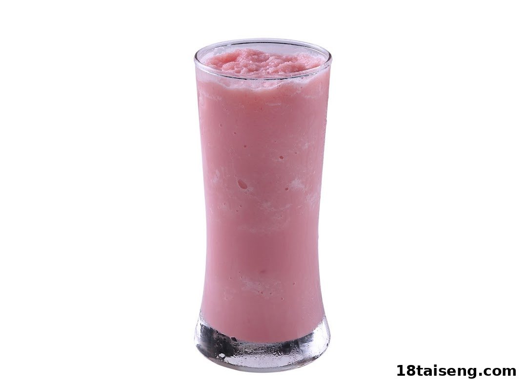 A tall glass filled with a refreshing pink blended drink, likely a smoothie or milkshake.
