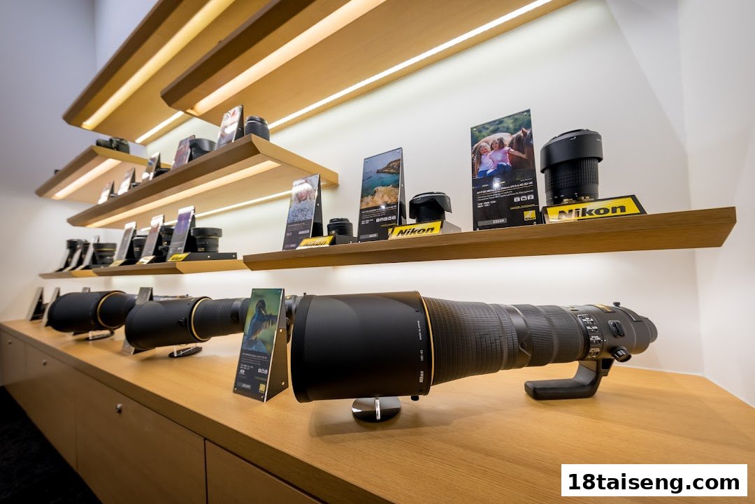 A well-lit display of Nikon camera lenses and equipment on wooden shelves in a retail store.
