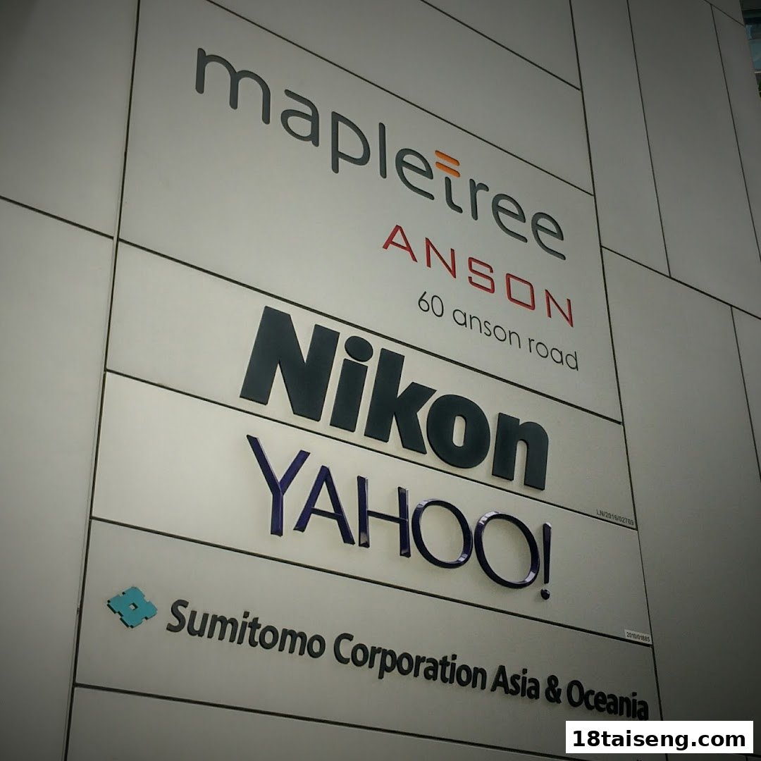 A building directory sign featuring the Nikon logo alongside other company names like Mapletree and Yahoo!.