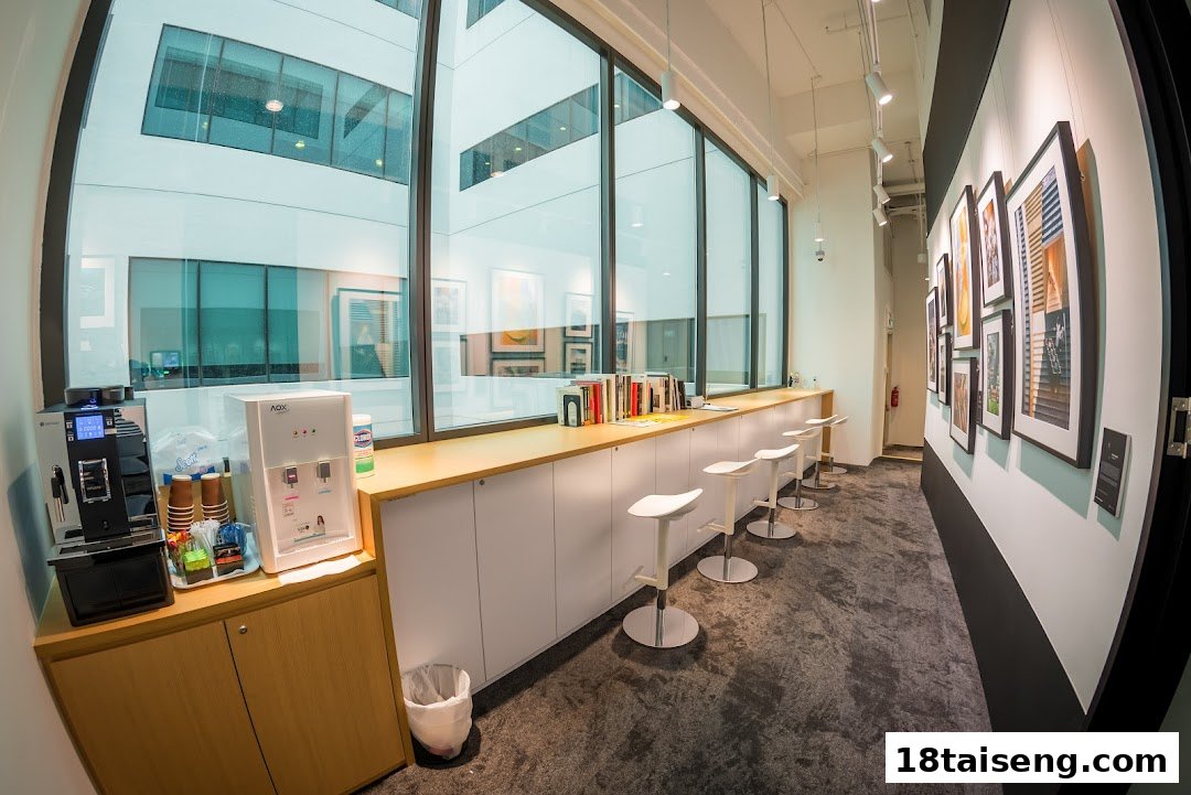 An interior view of Nikon Singapore featuring a counter with stools, coffee machine, and framed photographs.