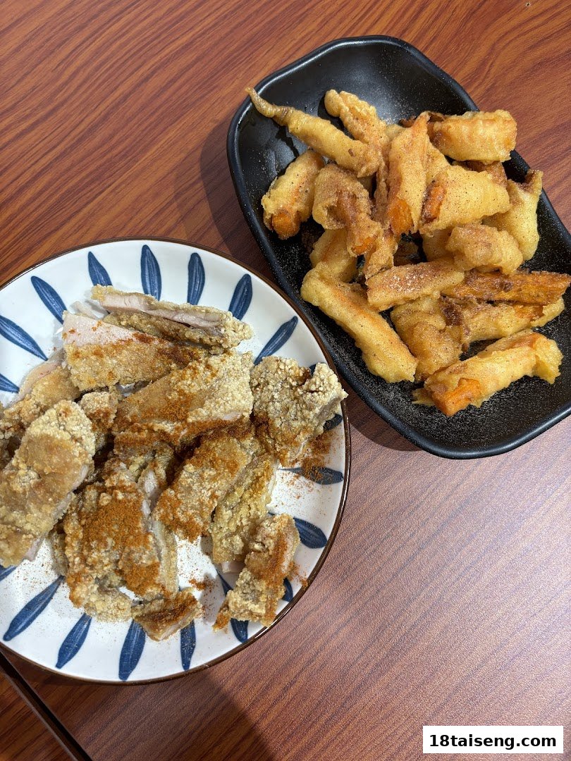 A plate of crispy fried chicken and a bowl of golden fried sweet potato fries.