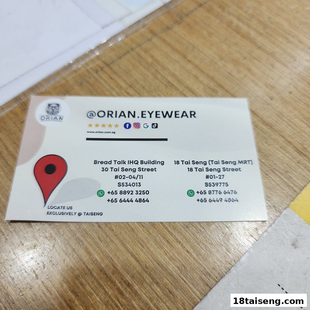 A business card for Orian Eyewear, displaying contact information and two Tai Seng locations.