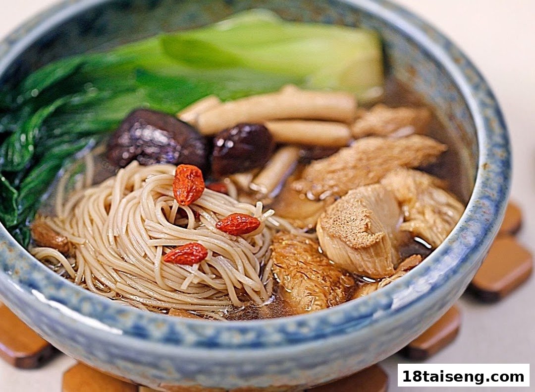 A close-up of a hearty vegetarian noodle soup with mushrooms, greens, and goji berries.