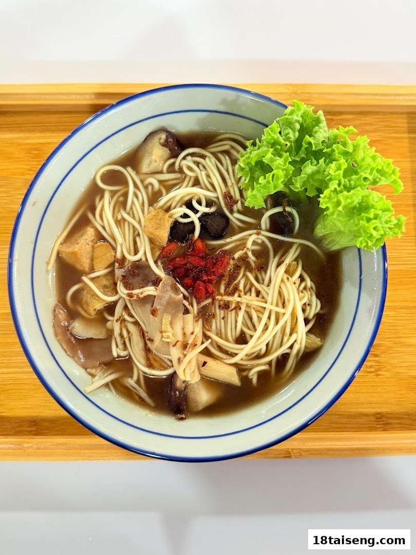 A delicious bowl of vegetarian noodles with mushrooms, tofu, and fresh greens on a wooden tray.