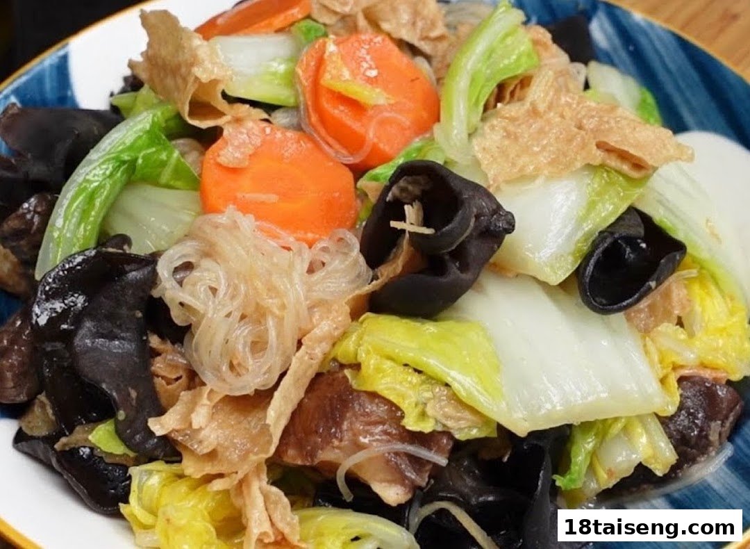 A vibrant close-up of a vegetarian stir-fry dish with various vegetables, mushrooms, and noodles.