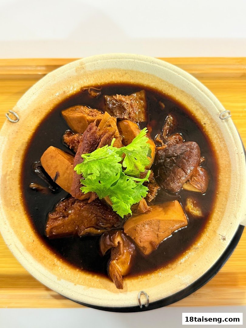 A delicious vegetarian claypot dish with tofu, mushrooms, and a rich dark sauce, garnished with fresh cilantro.