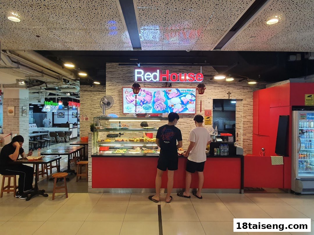 Customers at the Red House food stall counter with a food display and digital menu board.