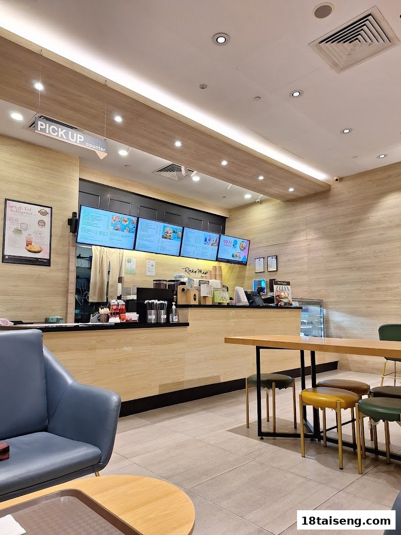 Interior view of Rocky Master cafe with counter, digital menus, and comfortable seating.