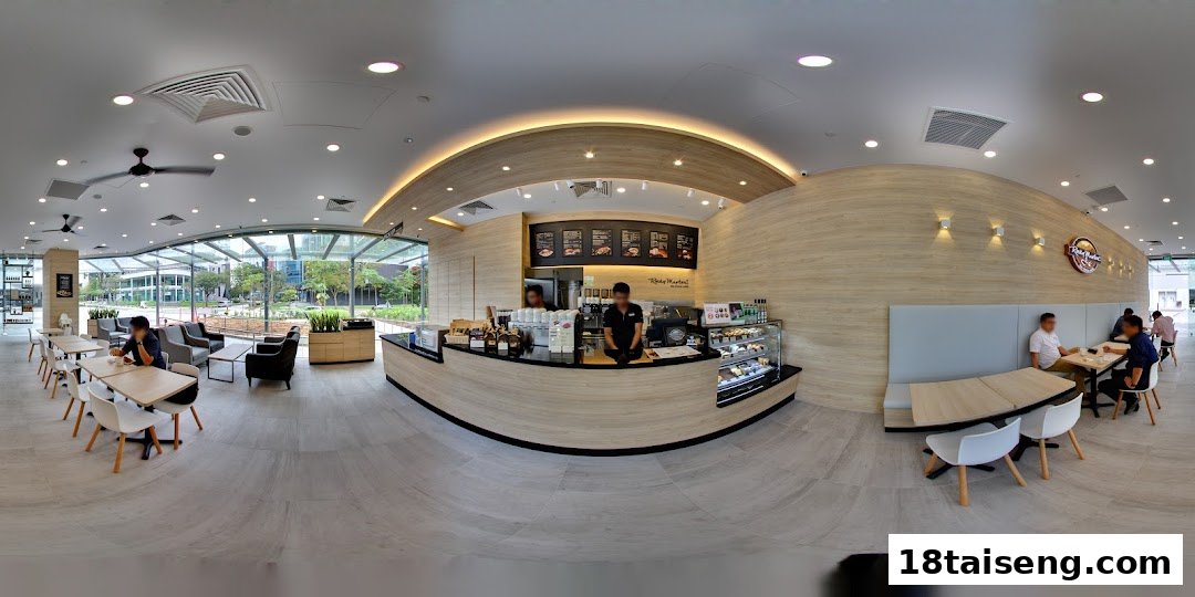 Spacious and modern interior of Rocky Master cafe with counter, various seating areas, and customers.