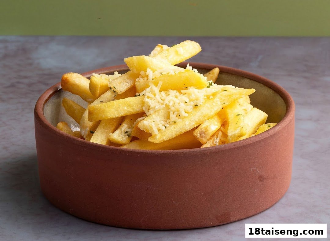 A rustic bowl filled with golden french fries topped with grated cheese and herbs.