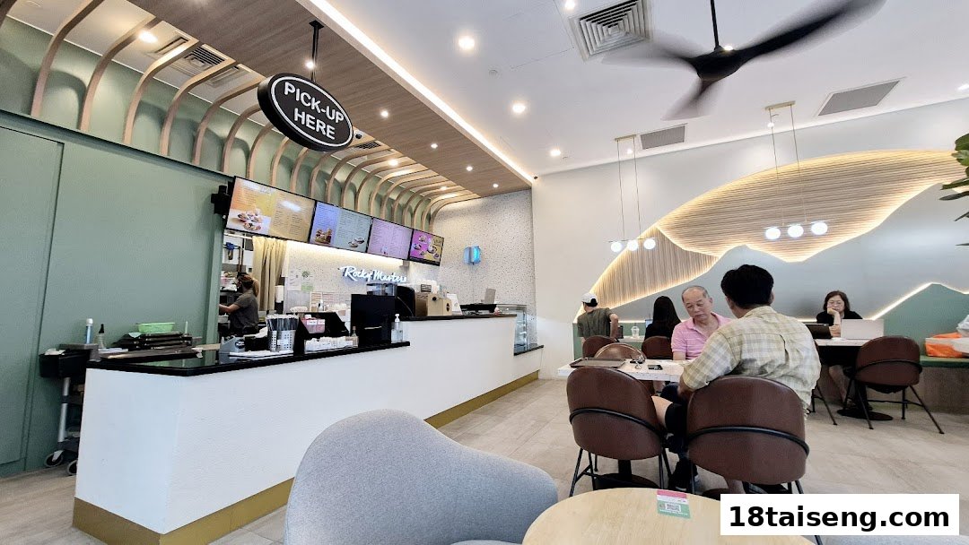 Interior view of Rocky Master cafe featuring the counter, seating area, and customers.