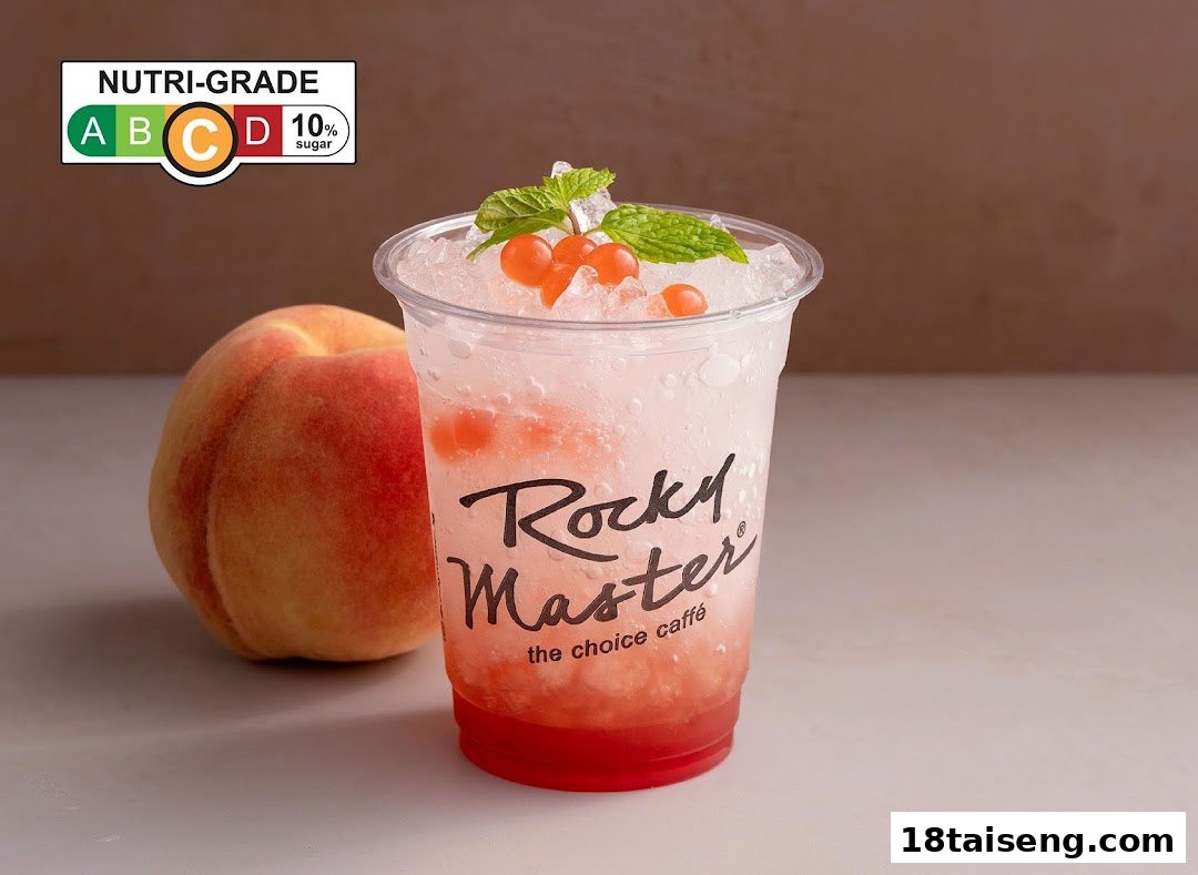 A refreshing peach-flavored sparkling drink with popping pearls and mint, alongside a fresh peach.