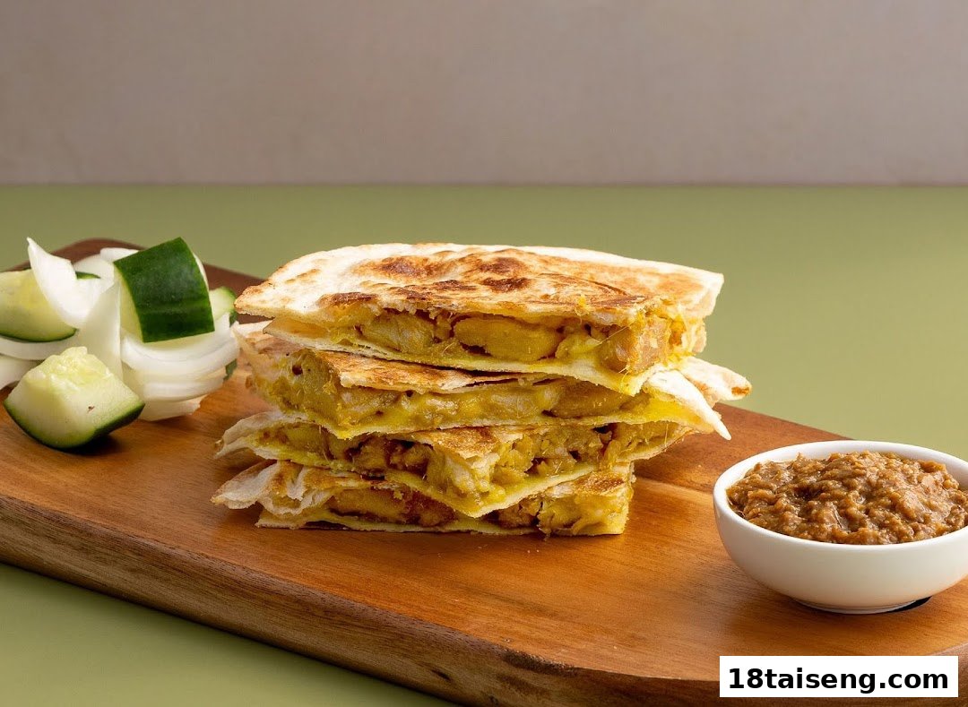 A stack of golden-brown quesadillas or flatbreads with a savory filling, served with a dip and fresh vegetables.