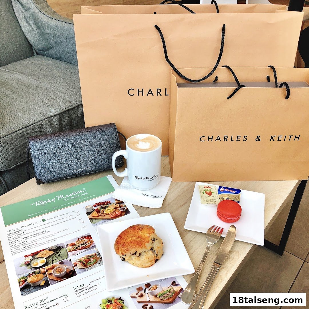 A table with coffee, pastries, shopping bags, and a partial menu from Rocky Master cafe.
