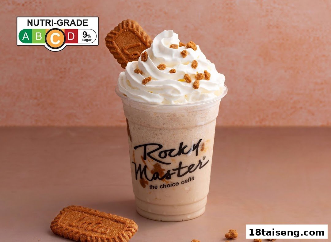 A Rocky Master frappe with whipped cream, cookie crumbs, and a Lotus Biscoff cookie, showing a Nutri-Grade C label.