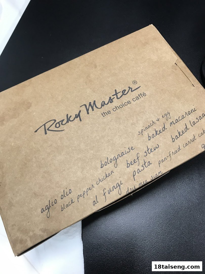 A brown takeaway box from Rocky Master with a handwritten list of food items.