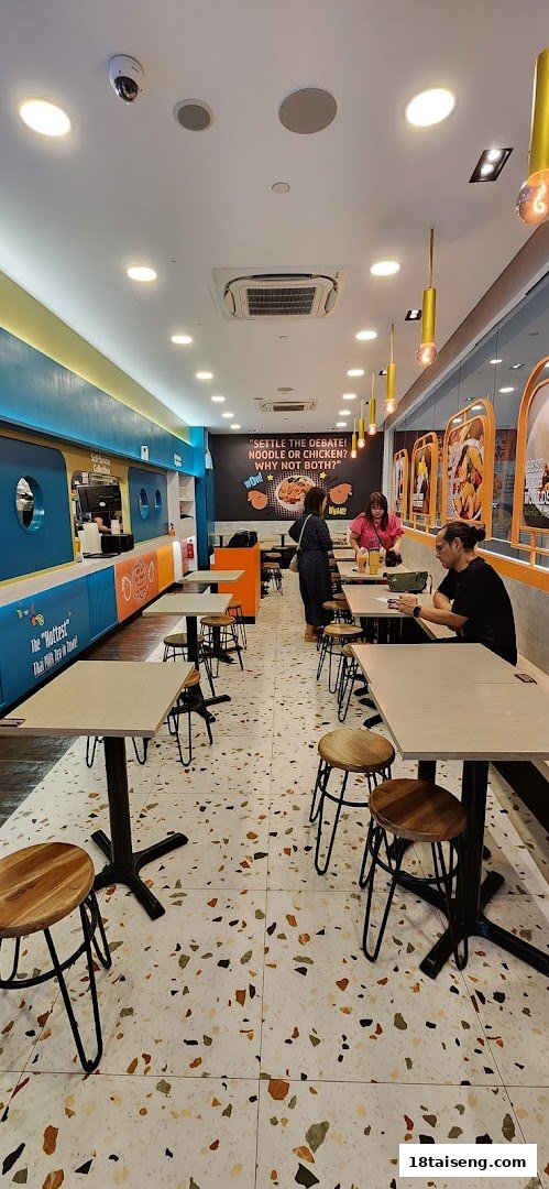 A vibrant interior shot of Saap Saap Thai, featuring modern decor, seating, and customers.