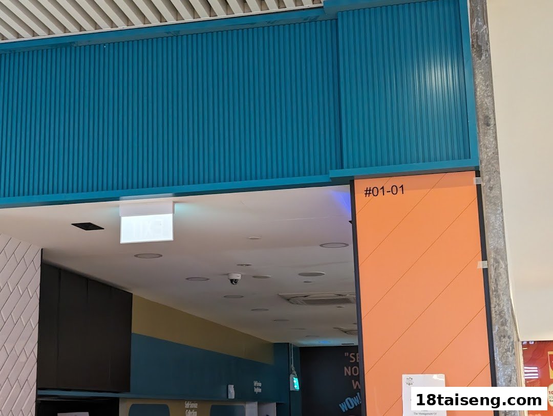 The vibrant blue and orange entrance of Saap Saap Thai at unit #01-01.