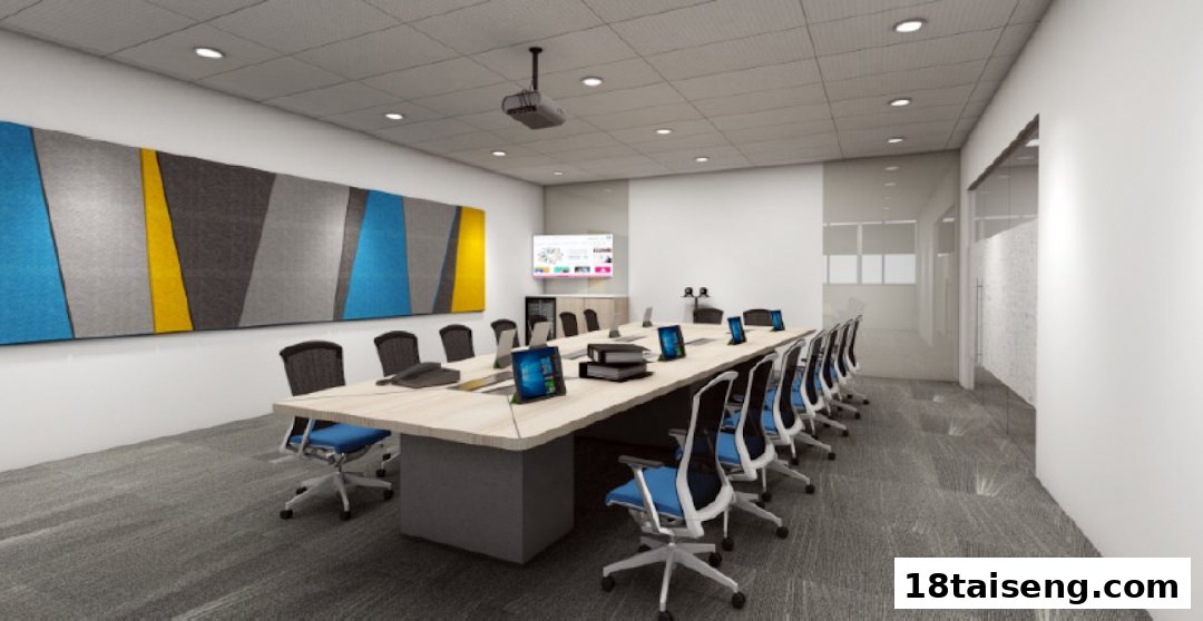 A modern, well-equipped meeting room with a large conference table and technology displays.