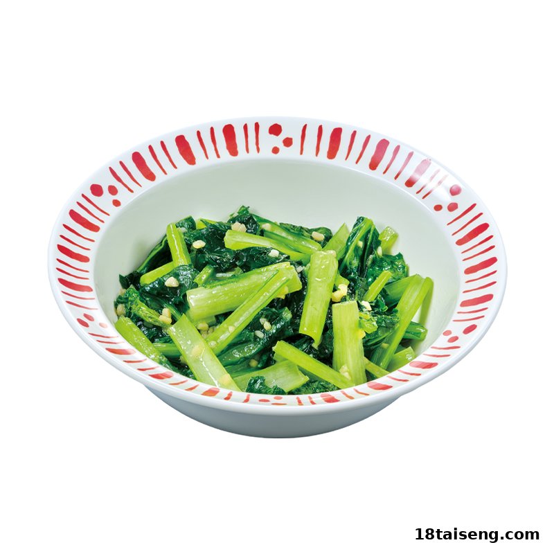 A white bowl with red trim filled with vibrant green leafy vegetables and minced garlic.