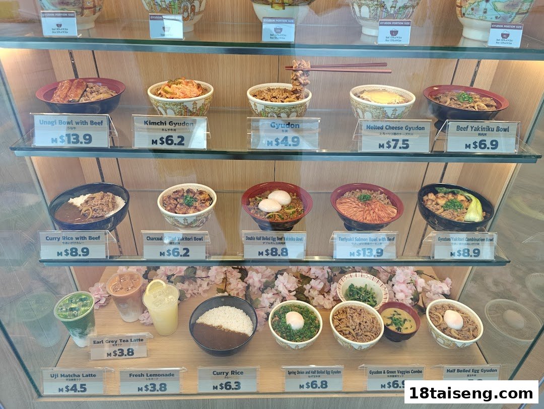 A display case showcasing various Japanese rice bowls, curries, and drinks with prices.