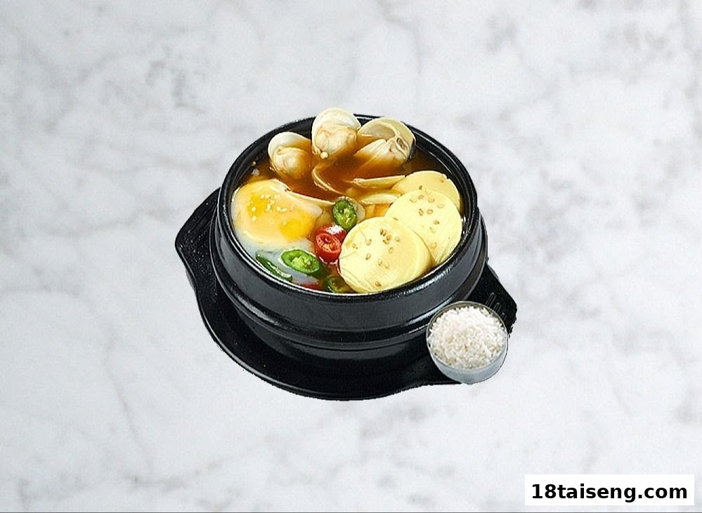 A hearty Korean stew with clams, tofu, egg, and chili, served with a side of rice.