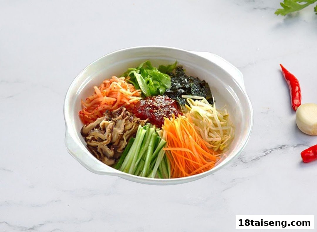 A vibrant bowl of Korean bibimbap with assorted vegetables, mushrooms, seaweed, and gochujang.