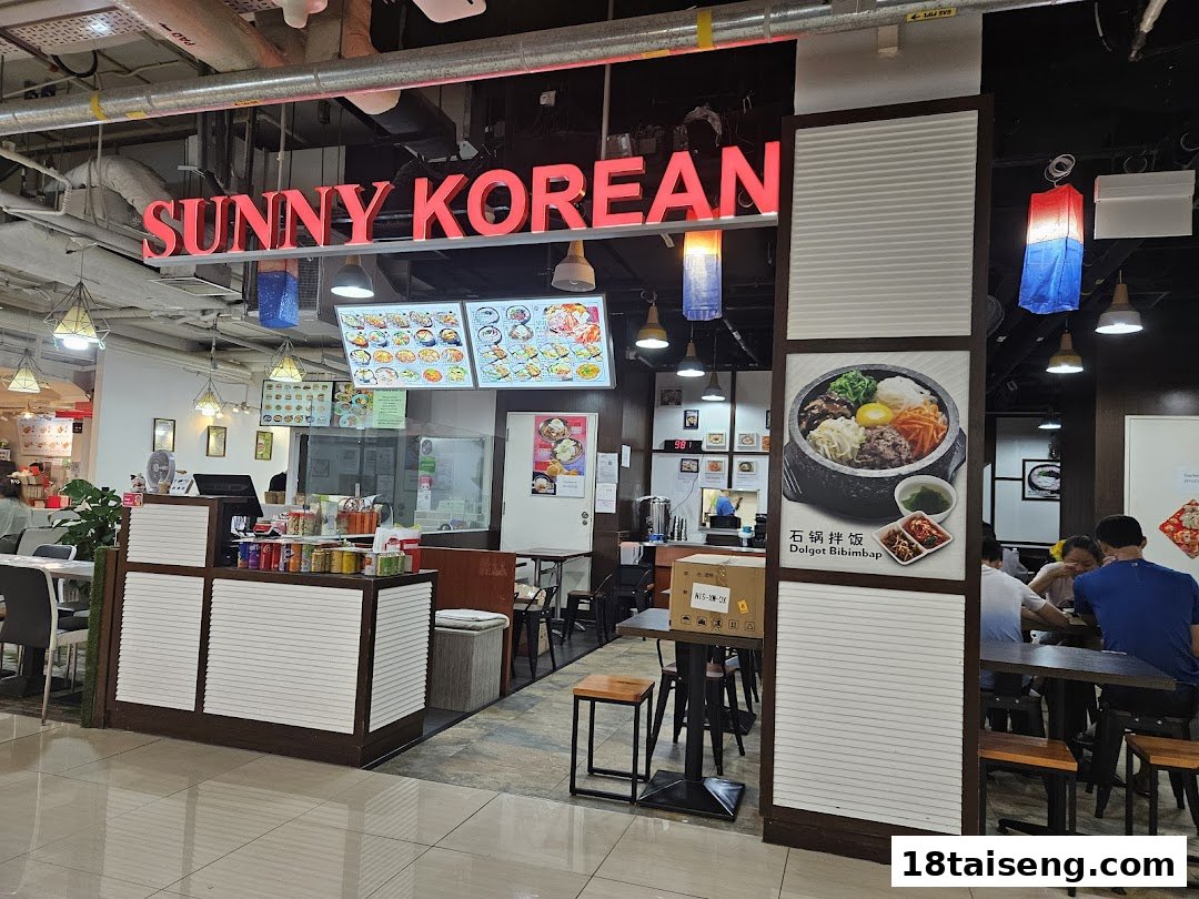 The vibrant entrance of Sunny Korean restaurant, featuring its bright signage and inviting dining area.