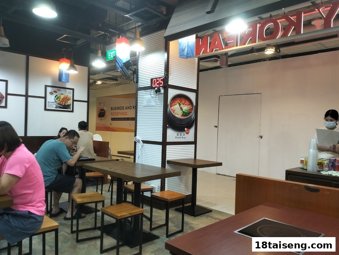 Diners enjoy authentic Korean cuisine in a vibrant restaurant interior with modern decor.