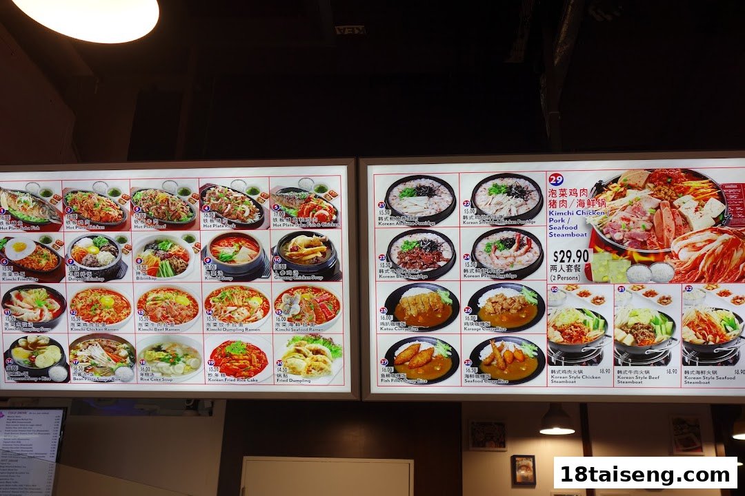 A brightly lit menu board showcasing a variety of Korean dishes with photos and prices.