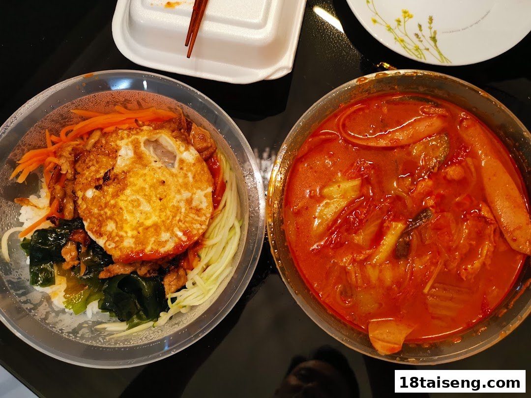 Two bowls of delicious Korean food, including bibimbap and a spicy stew, ready to be enjoyed.