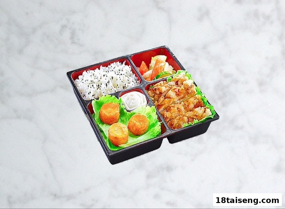 A delicious bento box featuring rice, fried chicken, side dishes, and fried items.