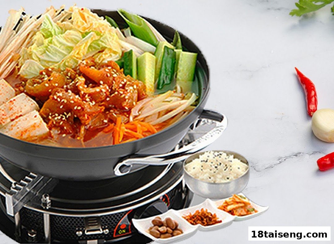A vibrant Korean hot pot with meat, vegetables, and tofu, served with rice and banchan.