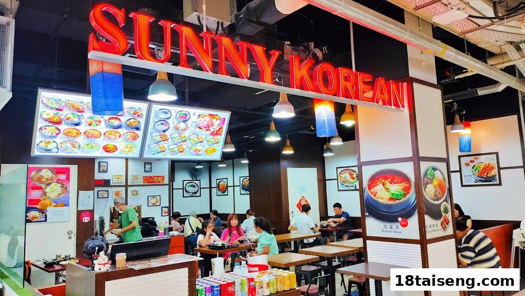 Interior view of Sunny Korean restaurant with customers dining and staff working.