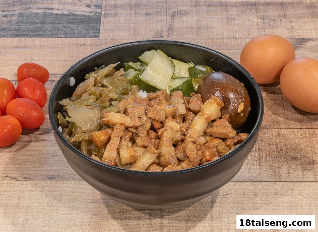 A delicious bowl of Taiwanese braised pork rice (Lu Rou Fan) with pickled vegetables and a braised egg.