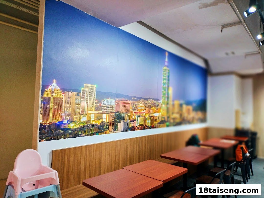 Interior view of Taiwan Ichiban featuring a vibrant Taipei city mural, wooden tables, and seating.