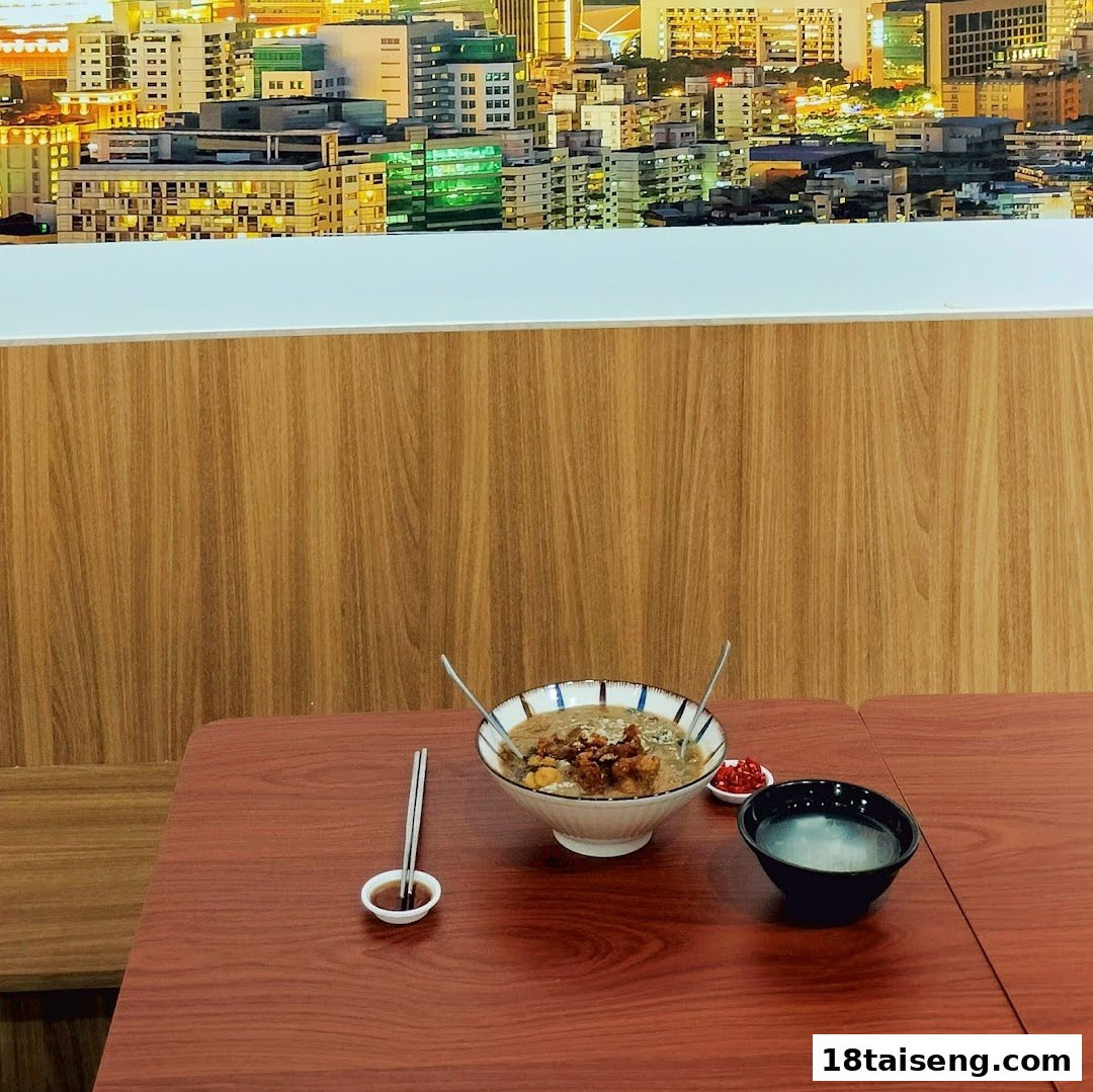 A delicious bowl of Taiwanese food on a wooden table with a city skyline mural in the background.