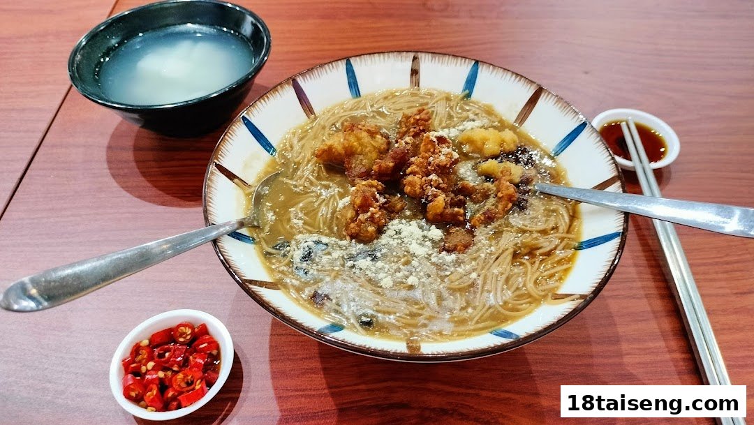 A delicious bowl of Taiwanese vermicelli with crispy fried chicken, served with chili and soup.