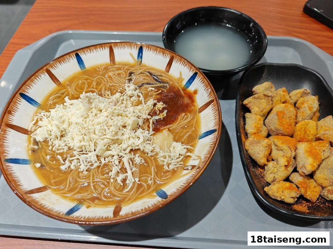 A delicious set meal featuring Taiwanese vermicelli noodles, crispy fried chicken, and a side soup on a tray.