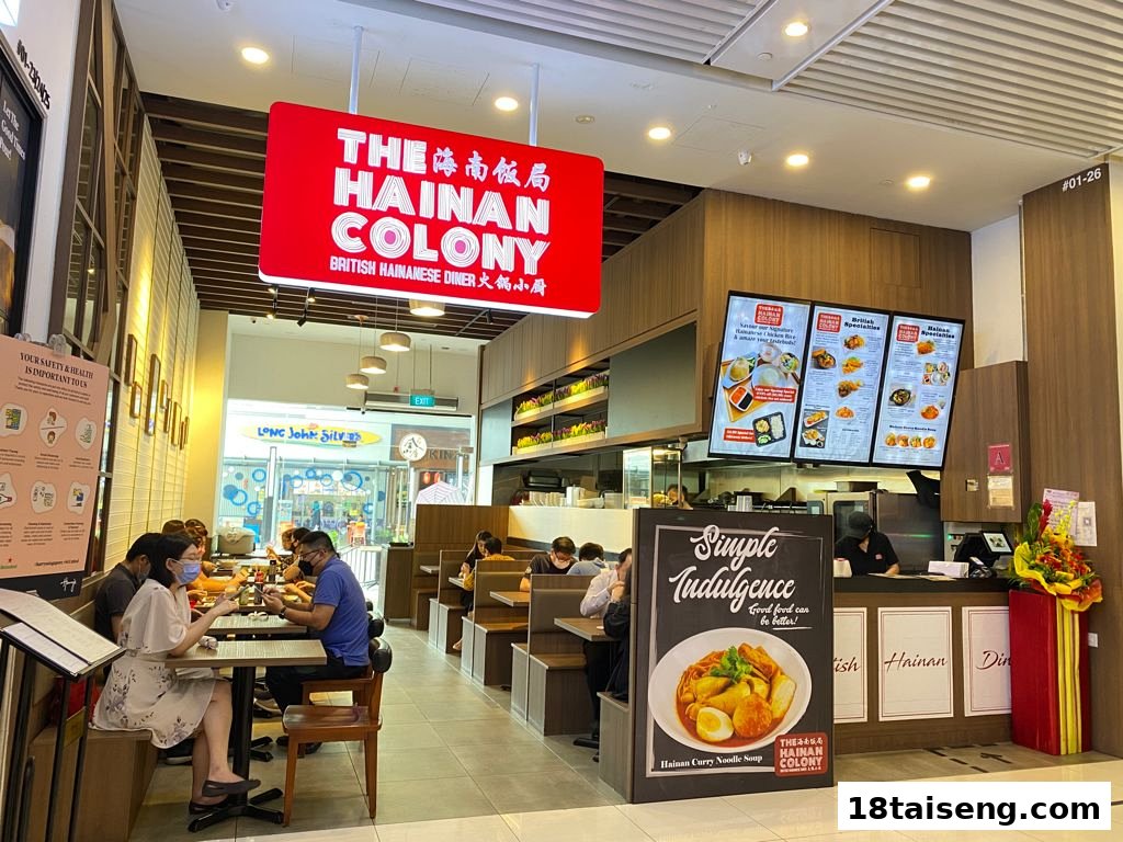 An interior view of The Hainan Colony diner, showing customers dining and the counter area.