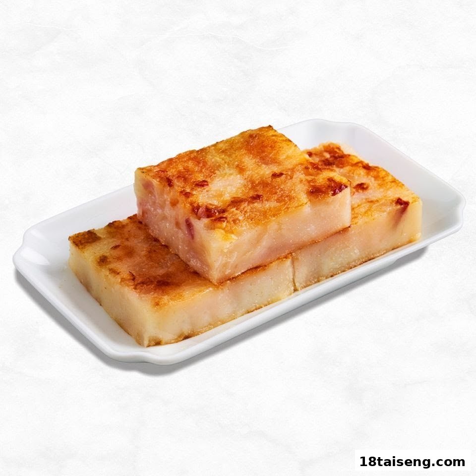 Three golden-brown pan-fried turnip cakes on a white rectangular plate.