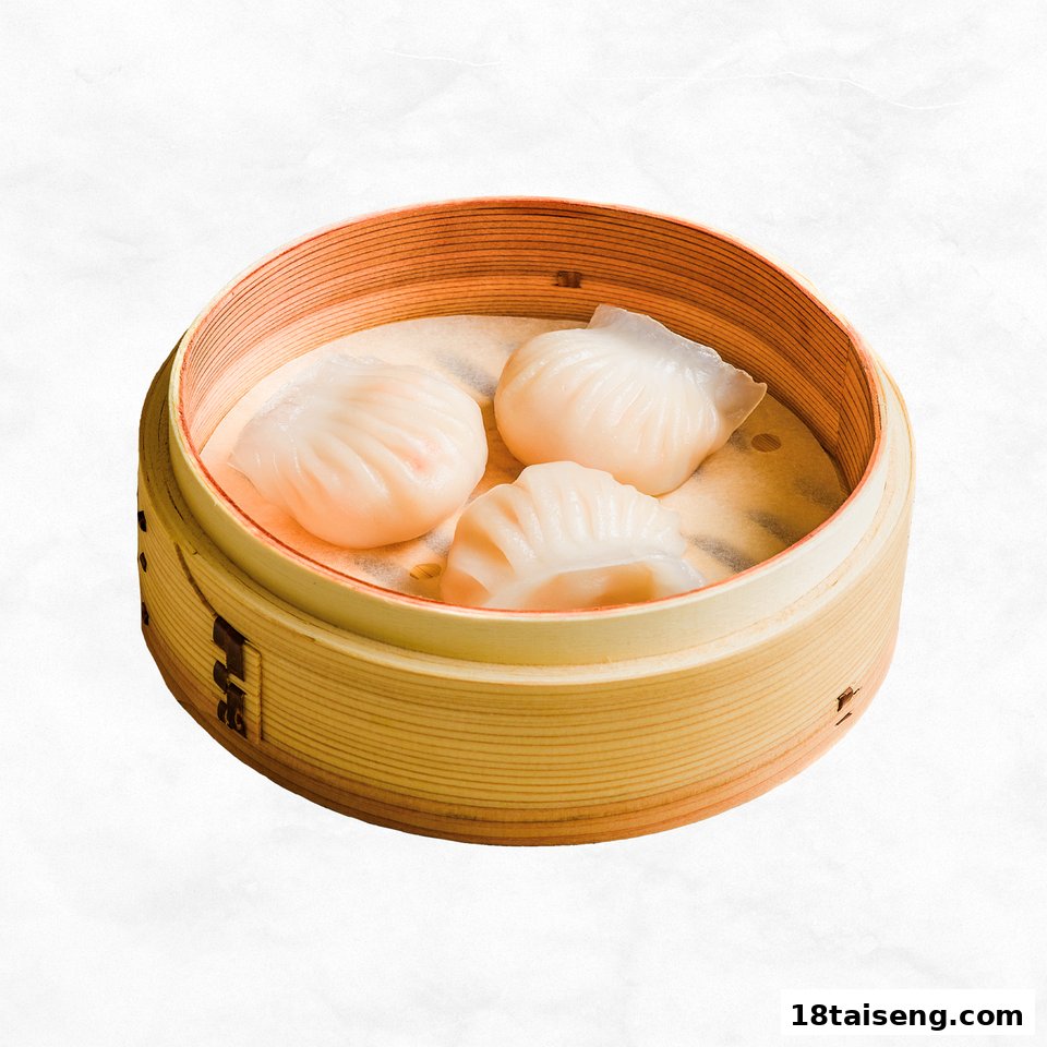 Three delicate steamed dumplings, likely har gow, presented in a traditional bamboo steamer.