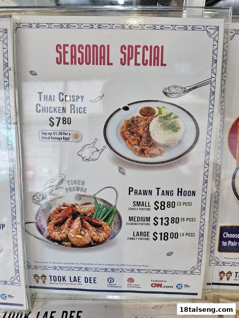 A menu board displaying seasonal specials for Thai Crispy Chicken Rice and Prawn Tang Hoon.