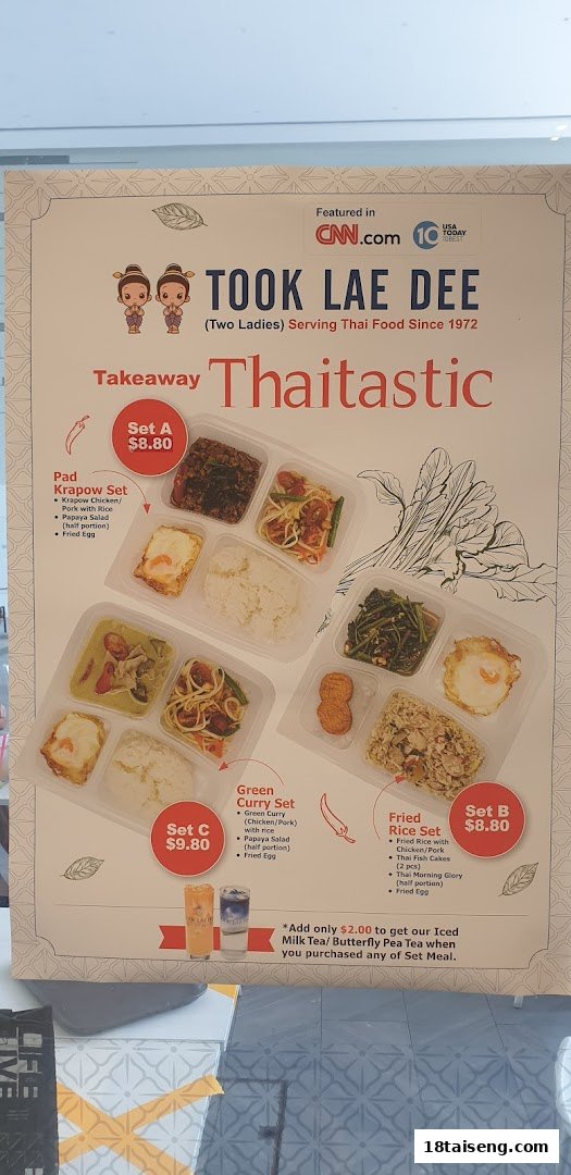 A menu board displaying takeaway Thai set meals with prices and descriptions from Took Lae Dee.