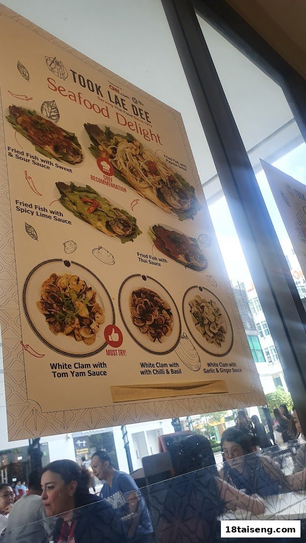 A promotional menu display for Took Lae Dee, showcasing various seafood dishes like fried fish and clams.