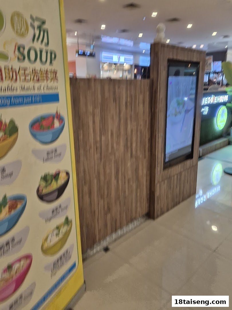 A vibrant banner advertising various soup options and a self-serve concept at Veggie House Vegetarian.