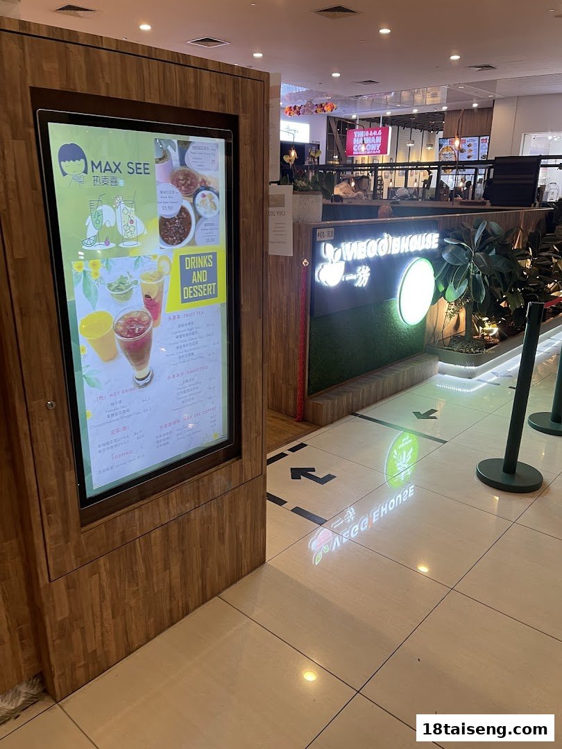 A digital menu display for MAX SEE drinks and desserts, located at the entrance of Veggie House.