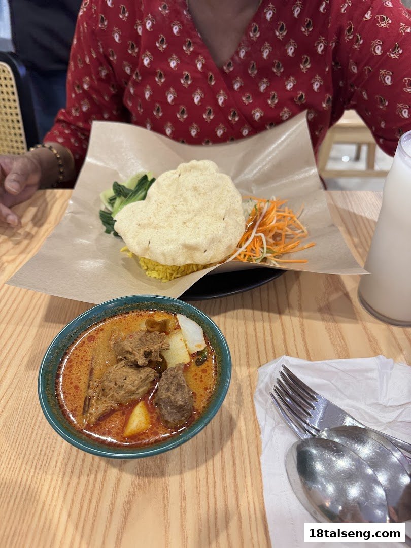 A table setting featuring two delicious vegetarian dishes, including a curry and a rice plate.