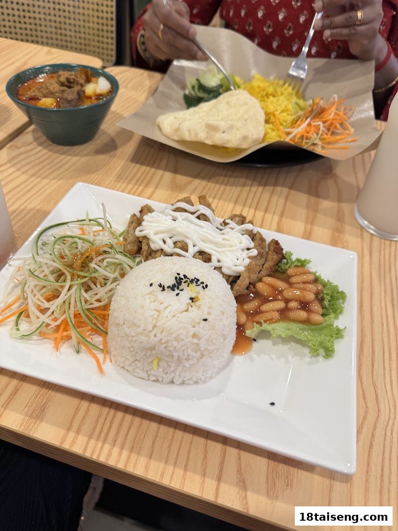 Two delicious vegetarian meals, including rice dishes and a curry, served on a wooden table.